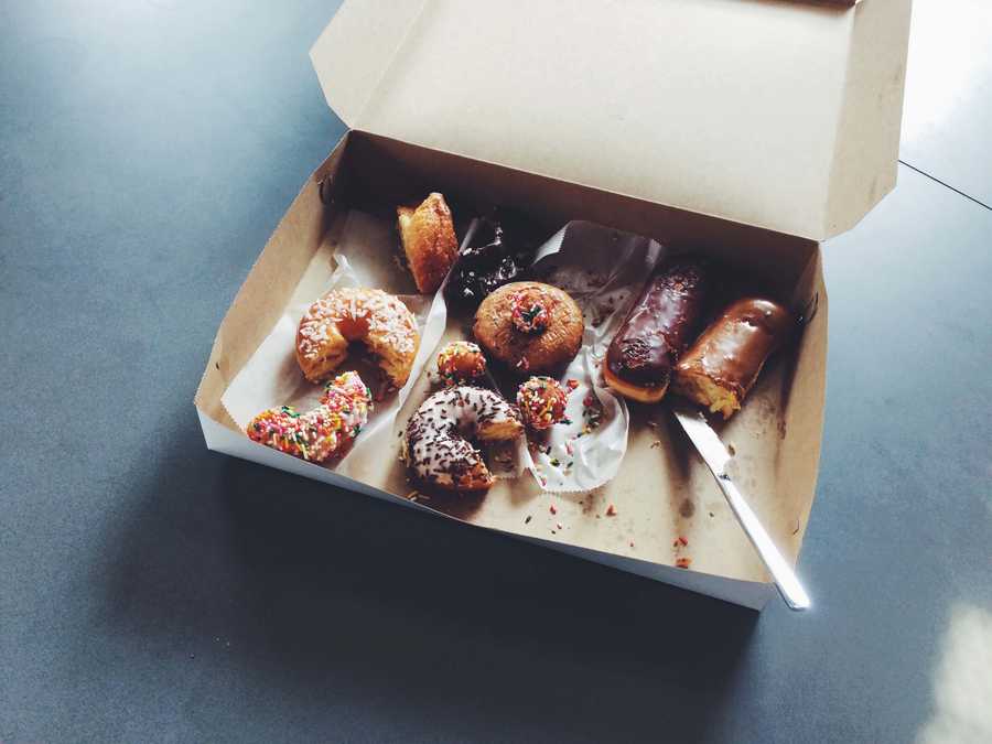 Box of partially eaten doughnuts