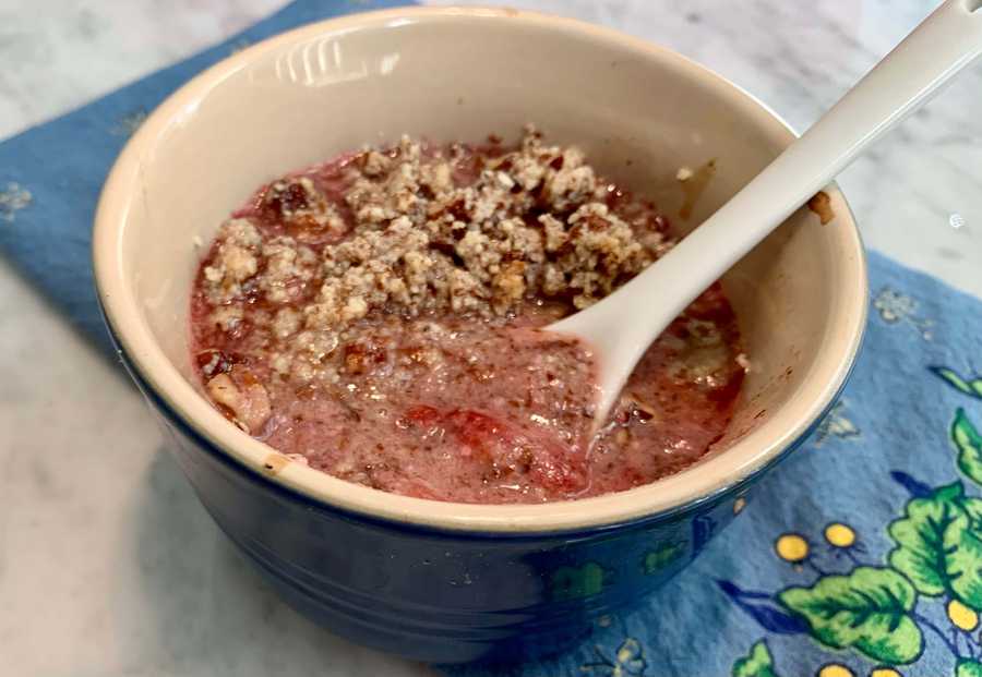 Strawberry fruit crisp in a blue ramekin