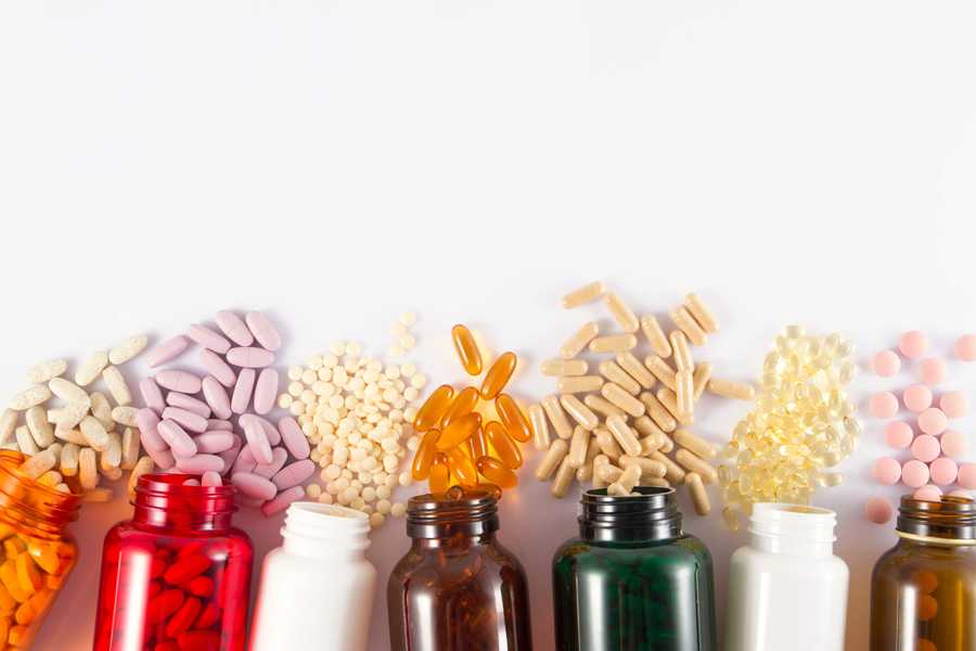 Bottles with different colored pills spilling out