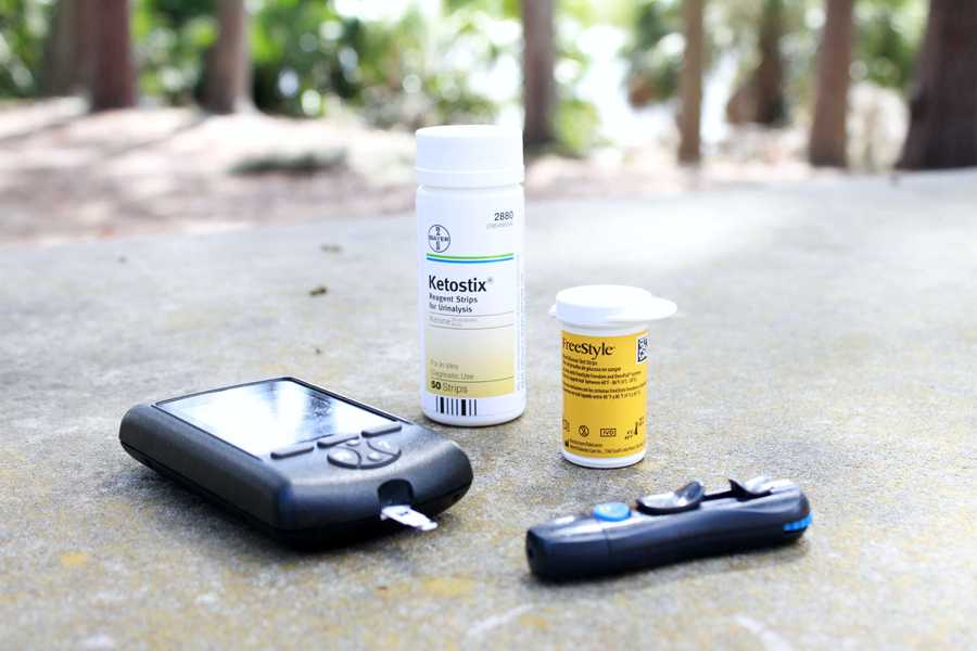 Ketone meter, lancet, and ketone strips on a table