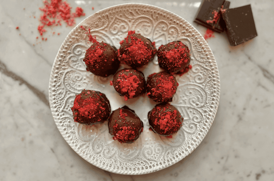 Homemade raspberry dark chocolate truffles on a platter